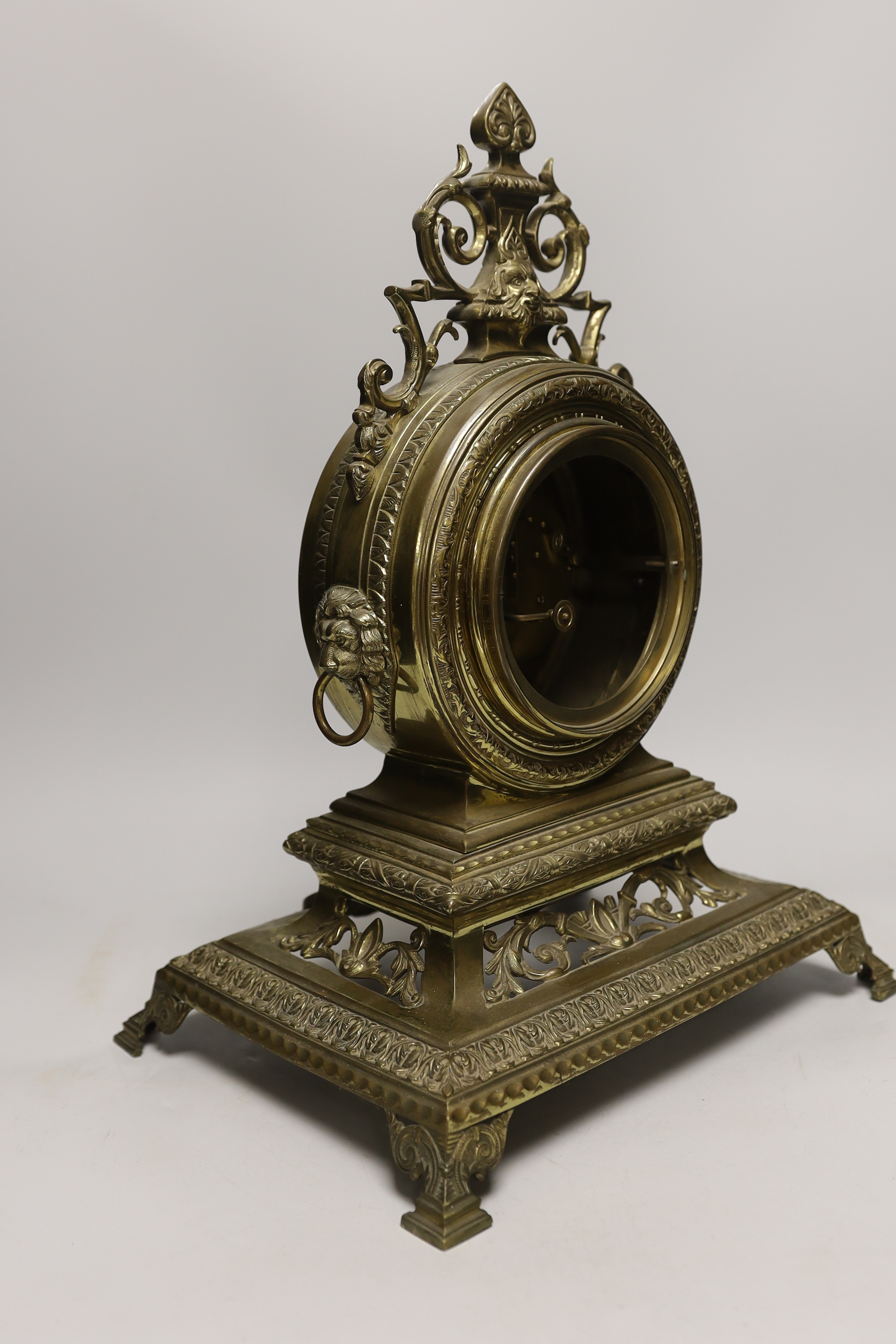 A late 19th century French Louis XIV revival brass drum shape clock, 46cm tall